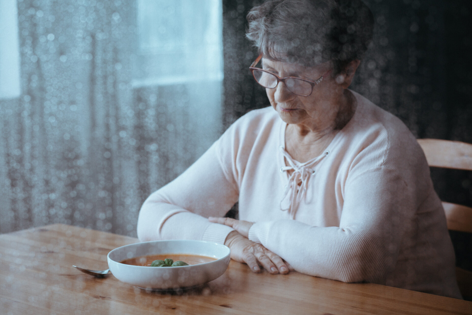 Sad, senior woman having lack of appetite eating disorder