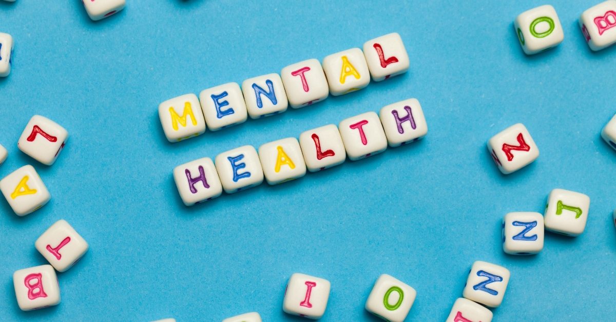 The words 'Mental Health' are spelled out in lettered dice